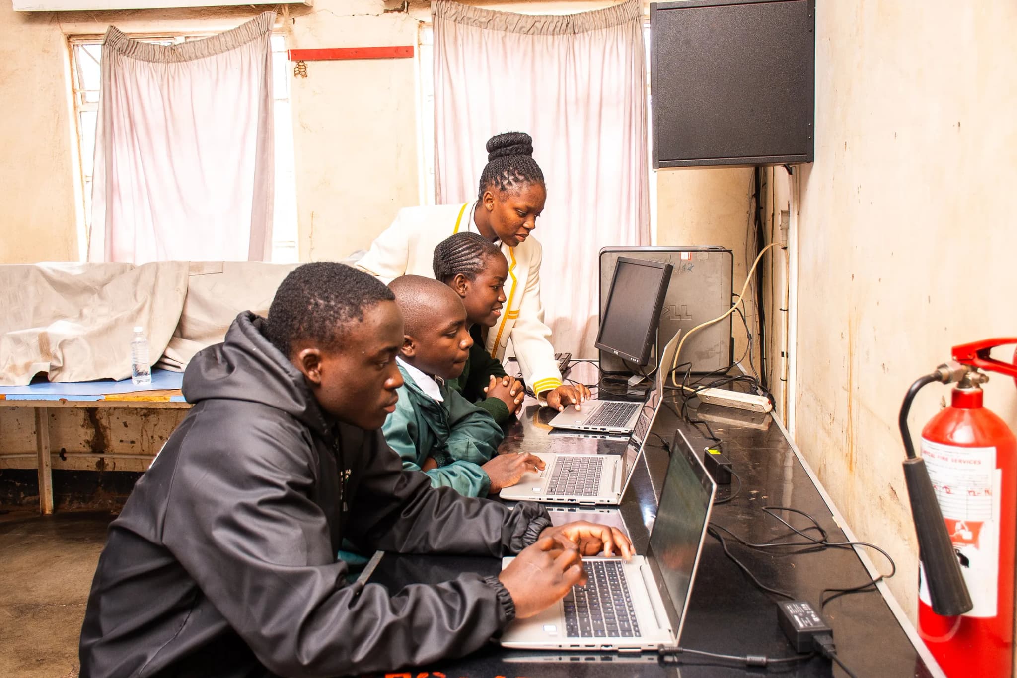 Students working on laptops in the solar-powered computer lab